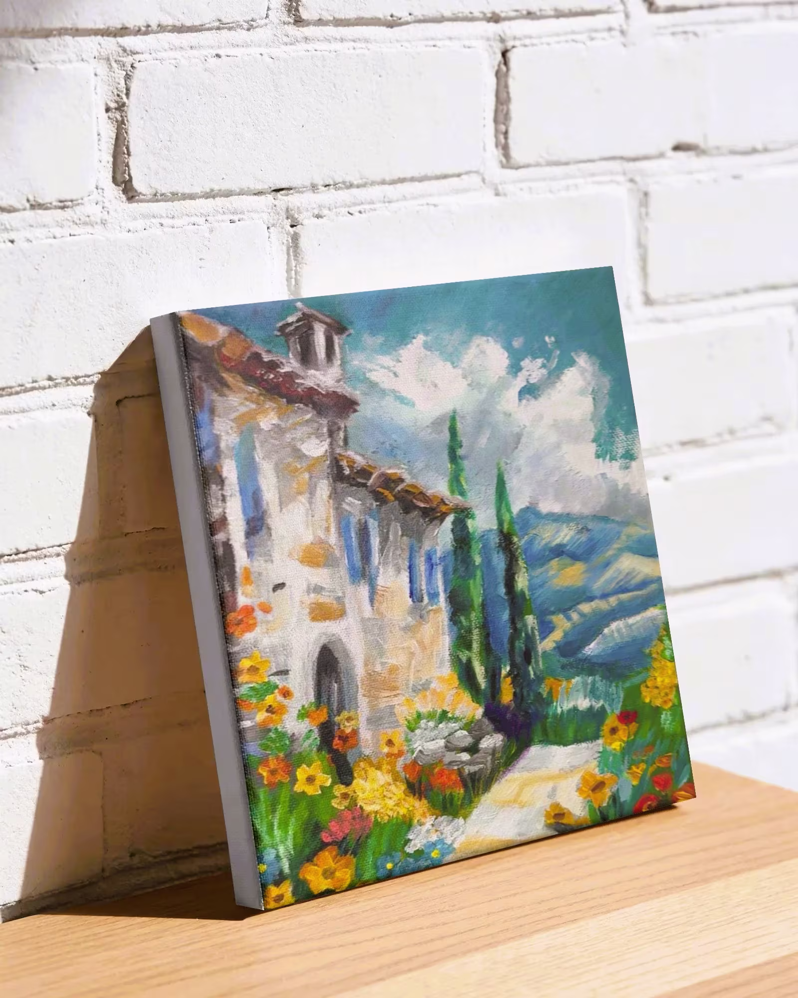 Colorful painting of a stone house with flowers, cypress trees, and a blue sky with clouds.